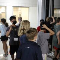 Students examine a glass walled elevator